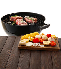 Table and barbecue grill with raw meat and vegetables on white background