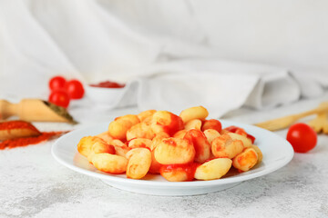 Plate with tasty gnocchi on table