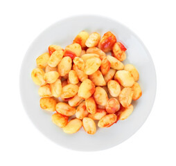 Plate with tasty gnocchi on white background