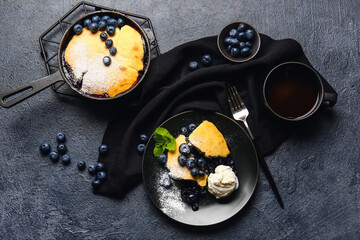 Composition with blueberry cobbler and ice cream on dark background