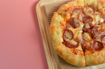 Close up view of Beef Pepperoni cheesy pizza isolated on pink background