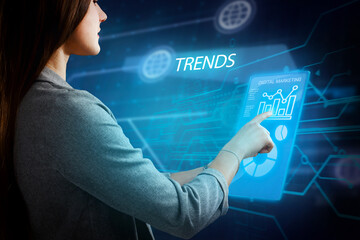 Business, Technology, Internet and network concept. Young businessman working on a virtual screen of the future and sees the inscription: Trends