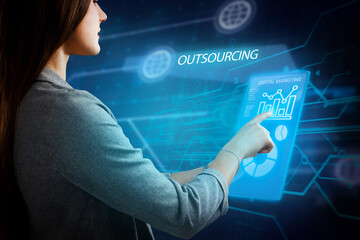 Business, Technology, Internet and network concept. Young businessman working on a virtual screen of the future and sees the inscription: Outsourcing