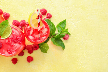 Fototapeta na wymiar Glasses with tasty raspberry lemonade on color background