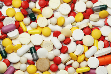 Different colorful tablets at white background	