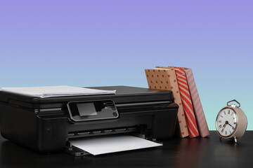 Home laser printer on desk against purple background