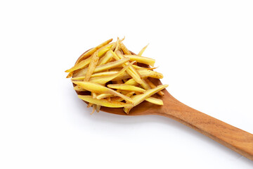 Sliced finger root in wooden spoon on white background.
