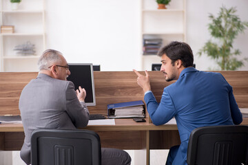 Two male employees working in the office