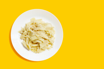 Preserved bamboo shoot slices in white plate on yellow background.
