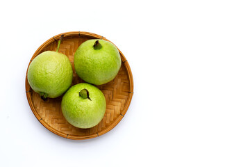 Fresh guava in bamboo baket on white background.