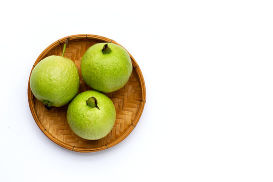 Fresh guava in bamboo baket on white background.