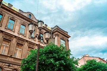 Street lamp on the background of a beautiful historical facade in St. Petersburg