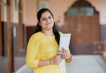 portrait of Smiling teacher in School corridor	
