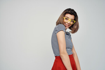 woman in striped t-shirt fashion glasses studio posing