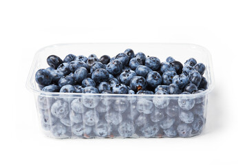 Fresh organic blueberries in a transparent plastic tray. Dark blue ripe fruits of Vaccinium...