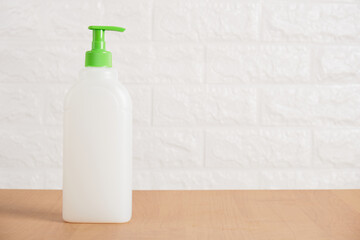 plastic blank bottle with dispenser for soap or dishwashing detergent on table