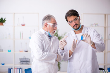 Fototapeta premium Two male chemists in drugs synthesis concept at the lab