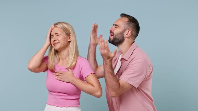 Young couple two actors family man woman in pink clothes start play emotion like movie theater after clapperboard gesture fainting begging isolated on pastel plain light blue color background studio