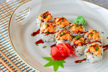 Japanese sushi with sesame seeds and cream icing on gray background