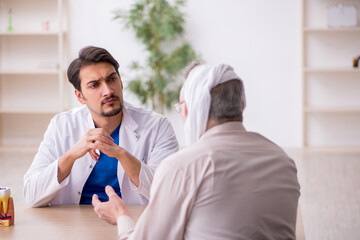 Old male patient visiting young male doctor dentist