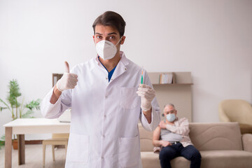 Young male doctor visiting old patient in vaccination concept
