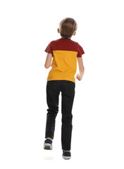 Little boy running on white background, back view