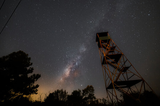 The firewatch tower under the milkyway in the night sky