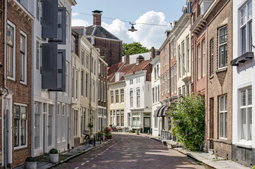Middelburg, the Netherlands, July 25, 2021: picturesque street with brick facades in the old town on a sunny day