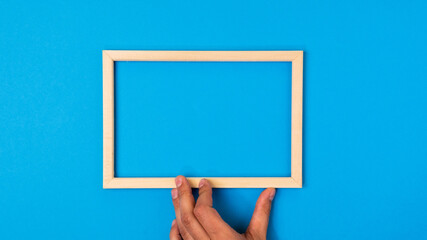 Wooden frame for copying text on a blue background