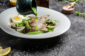 coal fish fillet with green asparagus, seafood, peas, asparagus and vegetable cream sauce. Delicious balanced food concept