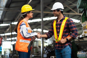 Quality control inspector checking workers at factory. Engineering Worker team working in Heavy Industry Manufacturing Facility.