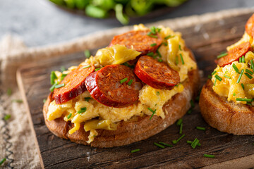 Scrambled eggs with sausage and herbs