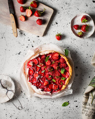 Strawberry cake with ricotta cheese. Summer dessert with berries and mint on a white table. A piece of cake on a ceramic plate. Fresh homemade cakes