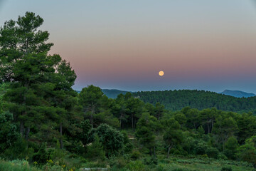 Sunrise in the Sierra de Mariola natural park with a full moon.