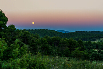 Sunrise in the Sierra de Mariola natural park with a full moon.