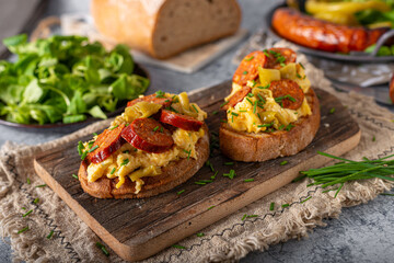 Scrambled eggs with sausage and herbs