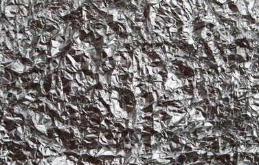 Background for banners and designs. The texture of the crumpled foil. Abstraction