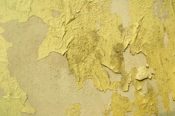 Background for banners and designs. A yellow old wall with peeling plaster. Wallpapers and textures. Abstraction
