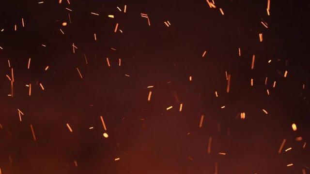 Sparks from a large fire fly up into the sky