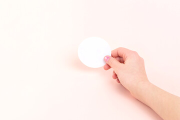 Mockup of round blank sticker in girl's hand