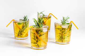 Herbal cold tea beverage with rosemary in glasses