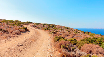 Dirt road to the shore of Mediterranean sea.