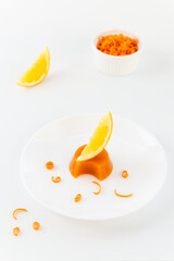 Pumpkin jelly with orange on a white plate.