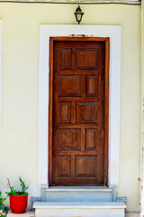 entrance brown wooden door with a house close-up