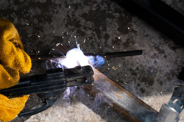 Welding work outdoors in a private house close-up.