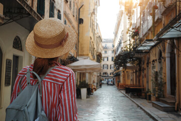 girl in a hat walks on the street of the ancient Greek city - obrazy, fototapety, plakaty