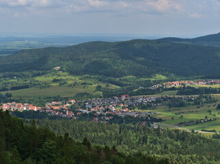 View over small villages Dürrwangen and Stockhausen, both part of Balingen, Germany located in a valley on the edge of low mountain range Swabian Alb surrounded by forests and fields in summer.