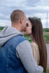 Fototapeta premium happy young couple outdoors near lake and green grass. bald man and brunette woman. husband and wife. millennials. successful marriage. true love
