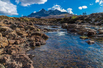 Fototapeta na wymiar A view up the River Sligachan with a backdrop of the Cuillin Hills on the Isle of Skye, Scotland on a summers day