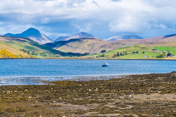 A view across the shore and waters of Loch Harport on  the Isle of Skye, Scotland on a summers day